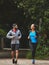 Couple, running in park for exercise and health outdoor, support and training for marathon with cardio. Runner, athlete