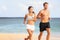 Couple running - sport runners jogging on beach