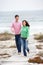 Couple running together along beach path