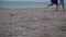 Couple runs on the beach feet view