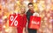 Couple with sale sign on shopping bags