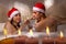 Couple in santa hats is enjoying a bath