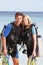 Couple With Scuba Diving Equipment Enjoying Beach Holiday