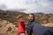 Couple selfie with outstretched arms, wind mountain summit, Golden Gate Highlands National Park, South Africa. Concept of adventur