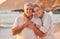 Couple, senior and beach with smile, hug and love on holiday, vacation or relax with romance. Elderly, woman and man by