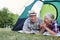 Couple of seniors camping in tent on campsite