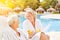 Couple of seniors with orange juice on spa vacation