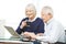 Couple of seniors surfing the internet with computer