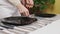 The couple served together table for family dinner, close-up. The couple arranges cutlery and cooked meals on the table