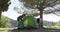 Couple setting tent under trees