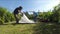 Couple setting up a camping tent in home garden.