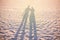 Couple shadow on the beach, sunset lighting, summer vacation concept unusual