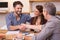 Couple shaking hand to financial agent