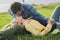 Couple share a romantic kiss laying on the grass