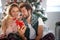 Couple sharing gifts on Chrismas morning; White Christmas concept