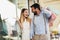 Couple with shopping bags is talking and smiling while doing shopping in the city