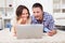 Couple shopping online using laptop and credit card