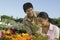 Couple Shopping at Plant Nursery smelling flowers