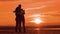 Couple silhouette doing selfie outdoors. Man and girl of best friends taking selfie during sunset. Modern concept of