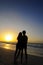 Couple silhouette on sunset ocean