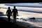 Couple silhouette walking at the seaside at sunset