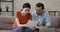 Couple sit on couch read paper letter celebrate great news