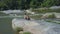 Couple Sit on Stone Hug Watch River against Jungle