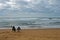 A couple siting on the beach Praia de Odeceixe in South Portugal