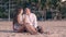 Couple sits and kisses on ocean beach in early evening