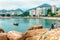 Couple sits on the rocks at Stanley Bay waterfront in Hong Kong. Beautiful scenic landscape with water, mountains, rocks and