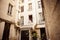 Couple sitting on the bedroom window of an apartment in the French court