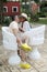 Couple sitting on a bench confidant chairs in Merida in Yucatan Mexico show their love with flirtatious looks and kisses