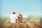 Couple Sitting Comfortable Beach Grass Holiday Concept