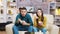 Couple sitting on couch eating noodles with chopstick