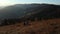 Couple sitting and enjoying mountains sunrise. Woman and man spend time together