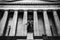 Couple Sitting in Front of Federal Building in Wall Street,. Greek Style Building in New York. Black and White Photography