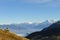 Couple sitting in the grass Bernese alps are in the background