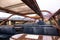 Couple sitting on interior seating inside a glass roofed sightseeing canal cruise trip boat for tourists