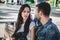 Couple sitting on a park bench looking at each other