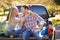 Couple Sitting In Pick Up Truck On Camping Holiday