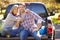 Couple Sitting In Pick Up Truck On Camping Holiday