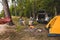 couple sitting in portable chairs drinking tea talking. camping summer activities