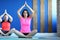 Couple sitting on rugs in a special yoga pose