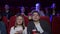 Couple sitting together in cinema, watching comedy or romantic movie.
