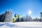 Couple of skiers on skis on hill at ski resort. Recreational activities in mountains concept. Low angle full-length shot