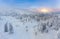 Couple skiing in a groomed curved double ski track with mountain