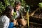 Couple smelling plants in garden