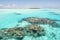 Couple snorkeling in turquoise clear water with coral reefs, South Pacific Ocean with Island, Aitutaki, Cook Islands