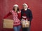 Couple in snowfall with Christmas present