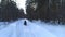 A couple on a snowmobile in the woods. Winter sports and entertainment.